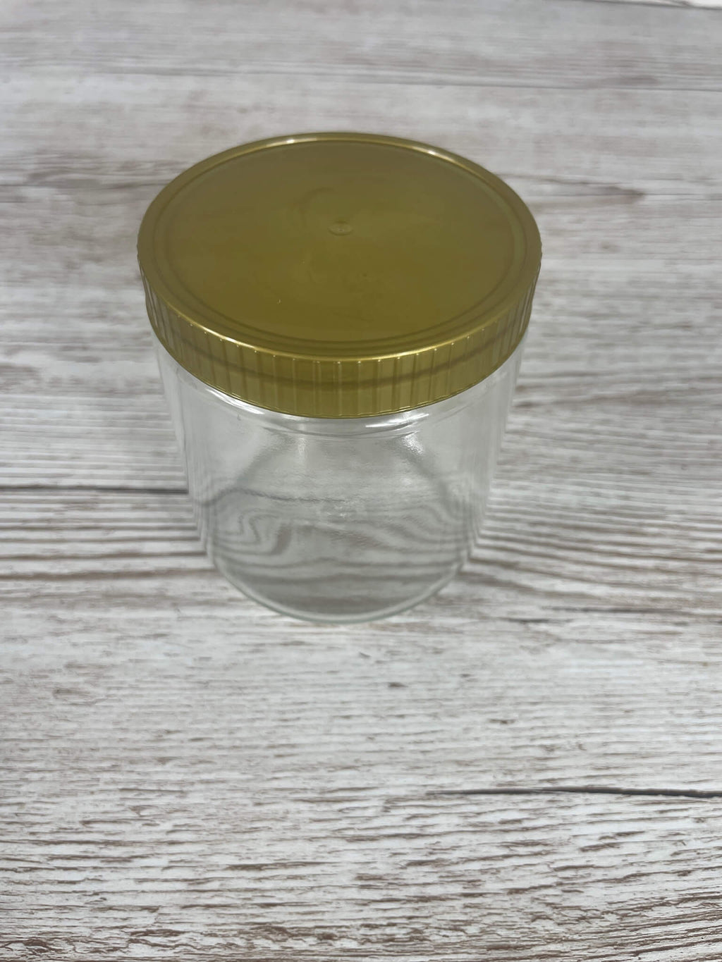 Geschlossenes 500g Neutralglas mit glatter Oberfläche und goldenem Twist-Off-Schraubverschluss